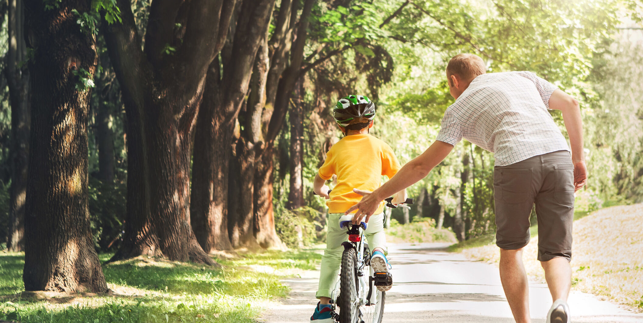 Father helping son ride a bicycle