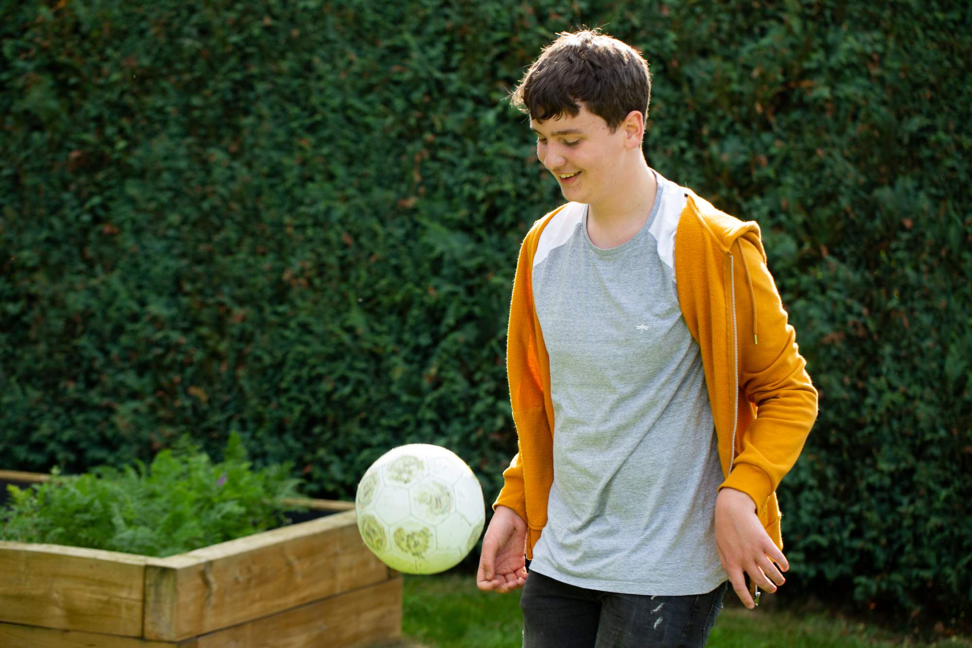 A teenage boy playing football