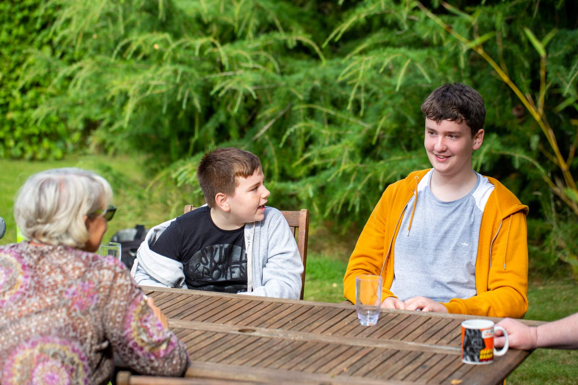 A mum and her two sons sat at their table talking