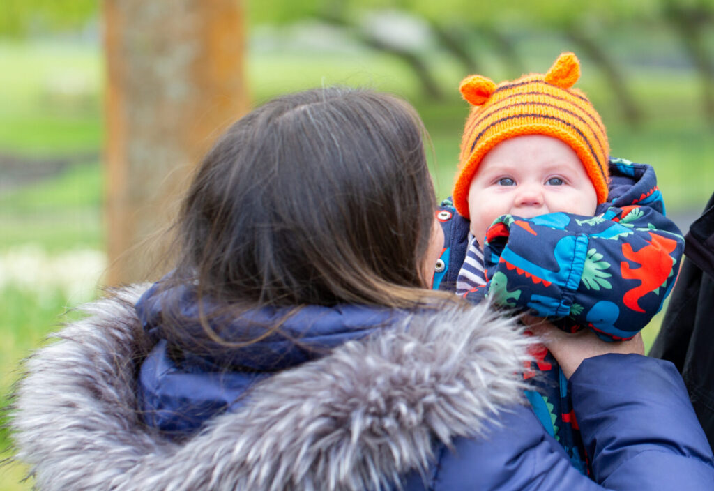 a female foster carer holding a young baby